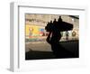 A Boy Carrying Bottles on His Head Passes by a Wall with Pictures of Haitian President Renel Preval-Ariana Cubillos-Framed Photographic Print