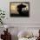 A Boy Carrying Bottles on His Head Passes by a Wall with Pictures of Haitian President Renel Preval-Ariana Cubillos-Framed Photographic Print displayed on a wall