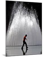 A Boy Crosses Over a Fountain-null-Mounted Photographic Print