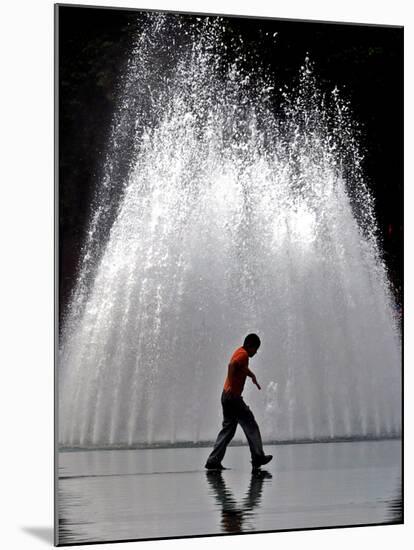 A Boy Crosses Over a Fountain-null-Mounted Photographic Print