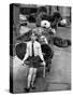 A Boy Gives a Ride to a Little Girl and a 9-Foot Teddy Bear at the Opening of the British Toy Fair-null-Stretched Canvas