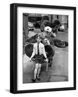 A Boy Gives a Ride to a Little Girl and a 9-Foot Teddy Bear at the Opening of the British Toy Fair-null-Framed Photographic Print