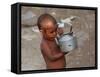 A Boy in a Slum Along the Yamuna River in the Older Part of New Delhi Drinks Water from a Tea Pot-null-Framed Stretched Canvas