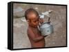 A Boy in a Slum Along the Yamuna River in the Older Part of New Delhi Drinks Water from a Tea Pot-null-Framed Stretched Canvas
