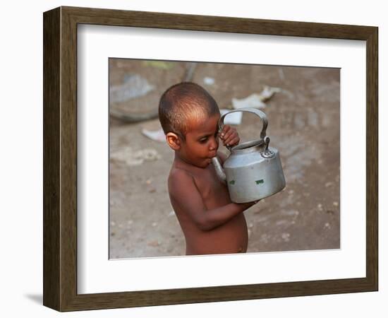 A Boy in a Slum Along the Yamuna River in the Older Part of New Delhi Drinks Water from a Tea Pot-null-Framed Photographic Print