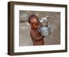 A Boy in a Slum Along the Yamuna River in the Older Part of New Delhi Drinks Water from a Tea Pot-null-Framed Photographic Print