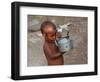 A Boy in a Slum Along the Yamuna River in the Older Part of New Delhi Drinks Water from a Tea Pot-null-Framed Photographic Print