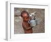 A Boy in a Slum Along the Yamuna River in the Older Part of New Delhi Drinks Water from a Tea Pot-null-Framed Photographic Print