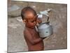 A Boy in a Slum Along the Yamuna River in the Older Part of New Delhi Drinks Water from a Tea Pot-null-Mounted Photographic Print