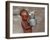 A Boy in a Slum Along the Yamuna River in the Older Part of New Delhi Drinks Water from a Tea Pot-null-Framed Photographic Print