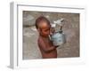 A Boy in a Slum Along the Yamuna River in the Older Part of New Delhi Drinks Water from a Tea Pot-null-Framed Photographic Print