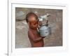 A Boy in a Slum Along the Yamuna River in the Older Part of New Delhi Drinks Water from a Tea Pot-null-Framed Photographic Print