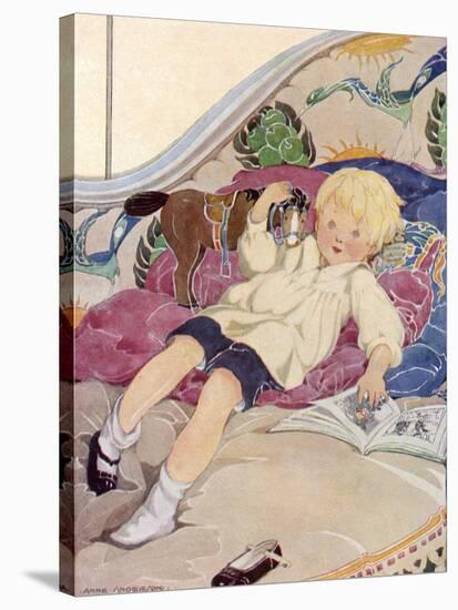 A Boy Lying on a Bed with a Book and a Toy Horse-Anne Anderson-Stretched Canvas