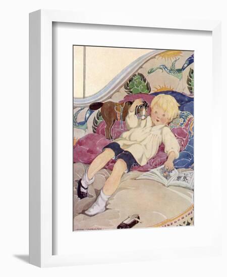 A Boy Lying on a Bed with a Book and a Toy Horse-Anne Anderson-Framed Art Print