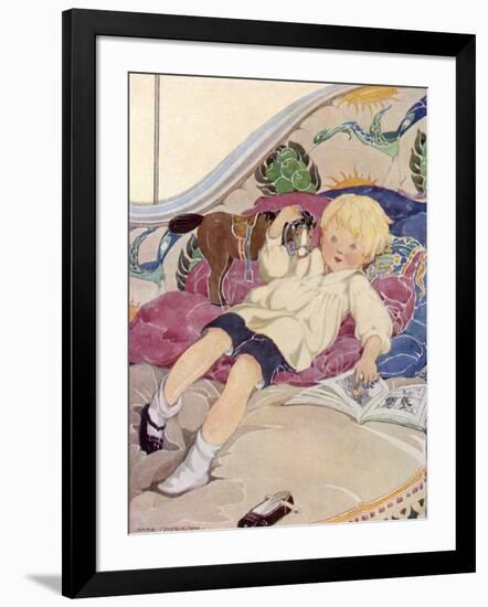 A Boy Lying on a Bed with a Book and a Toy Horse-Anne Anderson-Framed Art Print