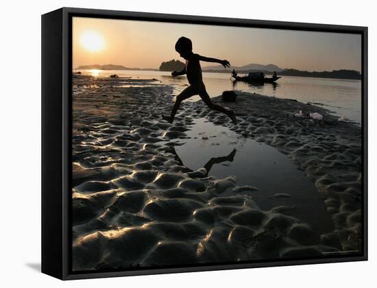 A Boy Plays on the Banks of the River Brahmaputra in Gauhati, India, Friday, October 27, 2006-Anupam Nath-Framed Stretched Canvas