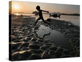 A Boy Plays on the Banks of the River Brahmaputra in Gauhati, India, Friday, October 27, 2006-Anupam Nath-Stretched Canvas