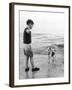 A Boy Throws Stones into the Sea for His Dog to Retrieve: the Dog Looks Up Expectantly-Henry Grant-Framed Photographic Print