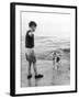 A Boy Throws Stones into the Sea for His Dog to Retrieve: the Dog Looks Up Expectantly-Henry Grant-Framed Photographic Print