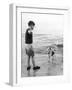 A Boy Throws Stones into the Sea for His Dog to Retrieve: the Dog Looks Up Expectantly-Henry Grant-Framed Photographic Print