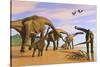 A Brachiosaurus Herd Walks Down a Wet Sandy Beach-null-Stretched Canvas