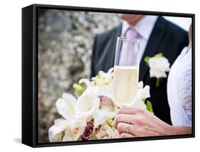 A Bride and Groom with a Glass of Champagne and a Bouquet-null-Framed Stretched Canvas