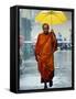 A Buddhist Monk Walks in the Rain on a Street in Bangkok-null-Framed Stretched Canvas