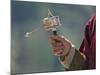 A Buddhist Spins His Hand-Held Prayer Wheel in a Clockwise Direction with the Help of a Weighted Ch-Nigel Pavitt-Mounted Photographic Print