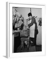 A Butcher Working in the Hungarian Meat Shop-John Phillips-Framed Premium Photographic Print