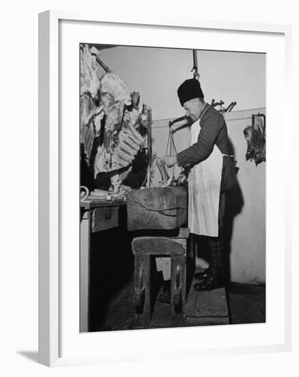 A Butcher Working in the Hungarian Meat Shop-John Phillips-Framed Premium Photographic Print