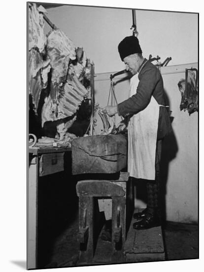A Butcher Working in the Hungarian Meat Shop-John Phillips-Mounted Premium Photographic Print
