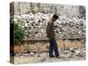 A Cambodian Man Walks Past One of the Many Killing Fields Sites-null-Stretched Canvas