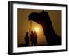 A Camel Stands as Villagers Walk at Sunrise at the Annual Cattle Fair in Pushkar, November 3, 2006-Rajesh Kumar Singh-Framed Photographic Print