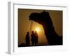 A Camel Stands as Villagers Walk at Sunrise at the Annual Cattle Fair in Pushkar, November 3, 2006-Rajesh Kumar Singh-Framed Photographic Print