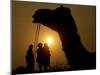 A Camel Stands as Villagers Walk at Sunrise at the Annual Cattle Fair in Pushkar, November 3, 2006-Rajesh Kumar Singh-Mounted Photographic Print