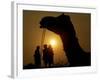 A Camel Stands as Villagers Walk at Sunrise at the Annual Cattle Fair in Pushkar, November 3, 2006-Rajesh Kumar Singh-Framed Photographic Print