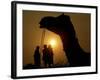 A Camel Stands as Villagers Walk at Sunrise at the Annual Cattle Fair in Pushkar, November 3, 2006-Rajesh Kumar Singh-Framed Photographic Print