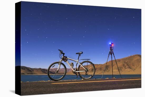 A Camera, Tripod and Bicycle on a Full Moon Night at Yamdrok Lake, Tibet, China-Stocktrek Images-Stretched Canvas