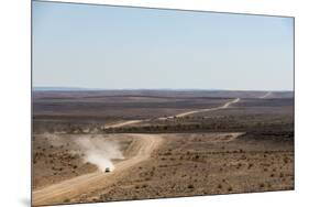 A Car Leaves a Cloud of Dust as it Apporachs Along the Long Dusty Road from the Fish River Canyon-Alex Treadway-Mounted Photographic Print