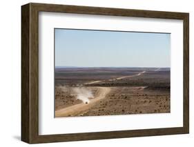 A Car Leaves a Cloud of Dust as it Apporachs Along the Long Dusty Road from the Fish River Canyon-Alex Treadway-Framed Photographic Print