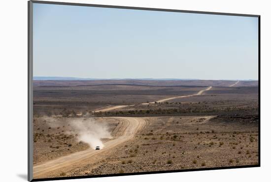 A Car Leaves a Cloud of Dust as it Apporachs Along the Long Dusty Road from the Fish River Canyon-Alex Treadway-Mounted Photographic Print