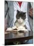 A Cat Joins its Owner Reading a Book at a Tokyo Cafe-null-Mounted Premium Photographic Print