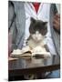 A Cat Joins its Owner Reading a Book at a Tokyo Cafe-null-Mounted Photographic Print