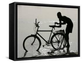 A Chadian Man Washes His Bicycle-null-Framed Stretched Canvas