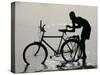 A Chadian Man Washes His Bicycle-null-Stretched Canvas