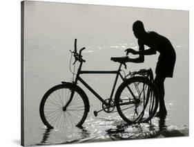 A Chadian Man Washes His Bicycle-null-Stretched Canvas