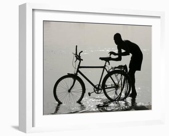 A Chadian Man Washes His Bicycle-null-Framed Premium Photographic Print