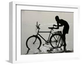 A Chadian Man Washes His Bicycle-null-Framed Premium Photographic Print