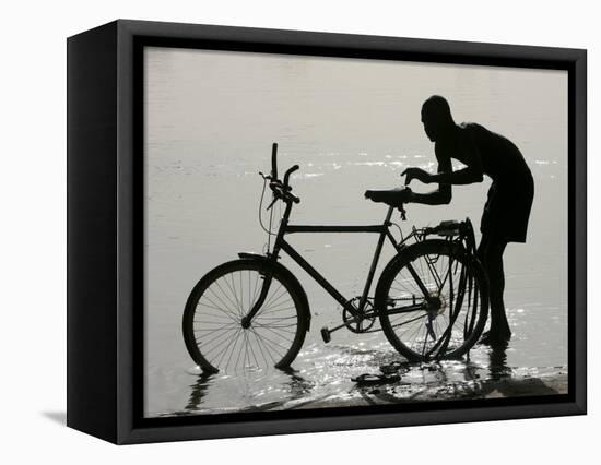 A Chadian Man Washes His Bicycle-null-Framed Stretched Canvas