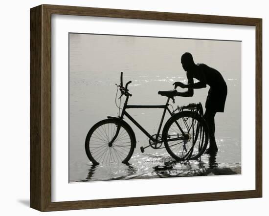 A Chadian Man Washes His Bicycle-null-Framed Photographic Print